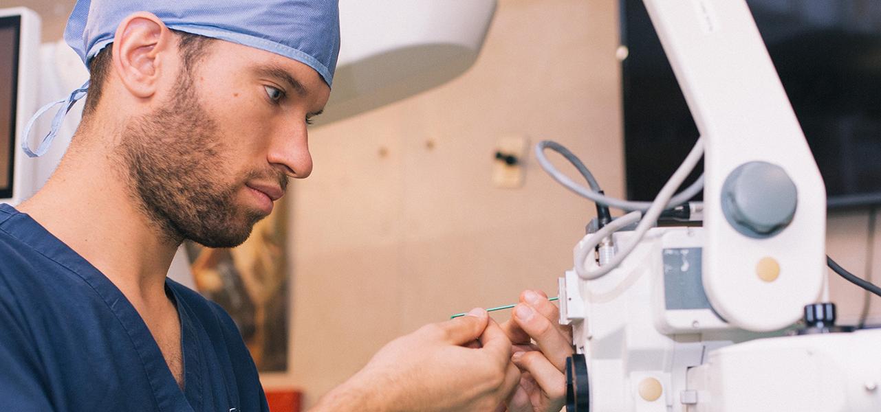 Man in scrubs hooking up testing